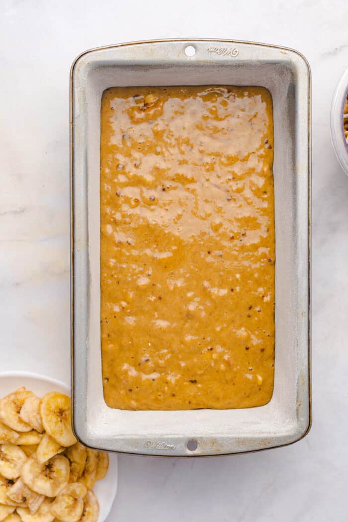 This copycat Starbucks Banana Bread is soft and moist, with lots of sweet banana flavor and warm spices. One bowl + 15 minutes! Banana bread batter in a loaf pan