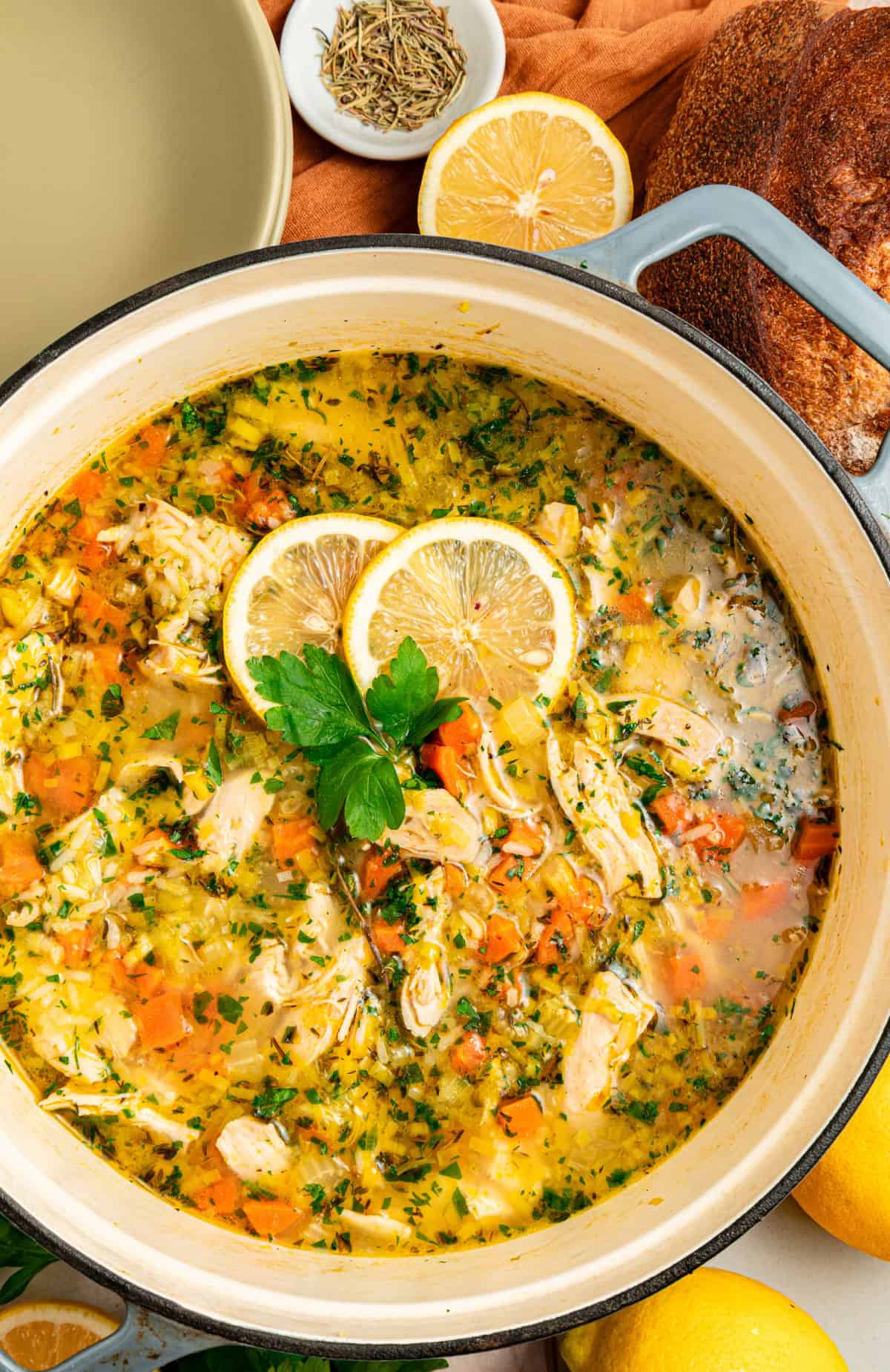 This Chicken and Leek Soup combines a buttery base of leeks, carrots and celery, tender shredded chicken, and long grain rice. Chicken and Leek soup in a pot