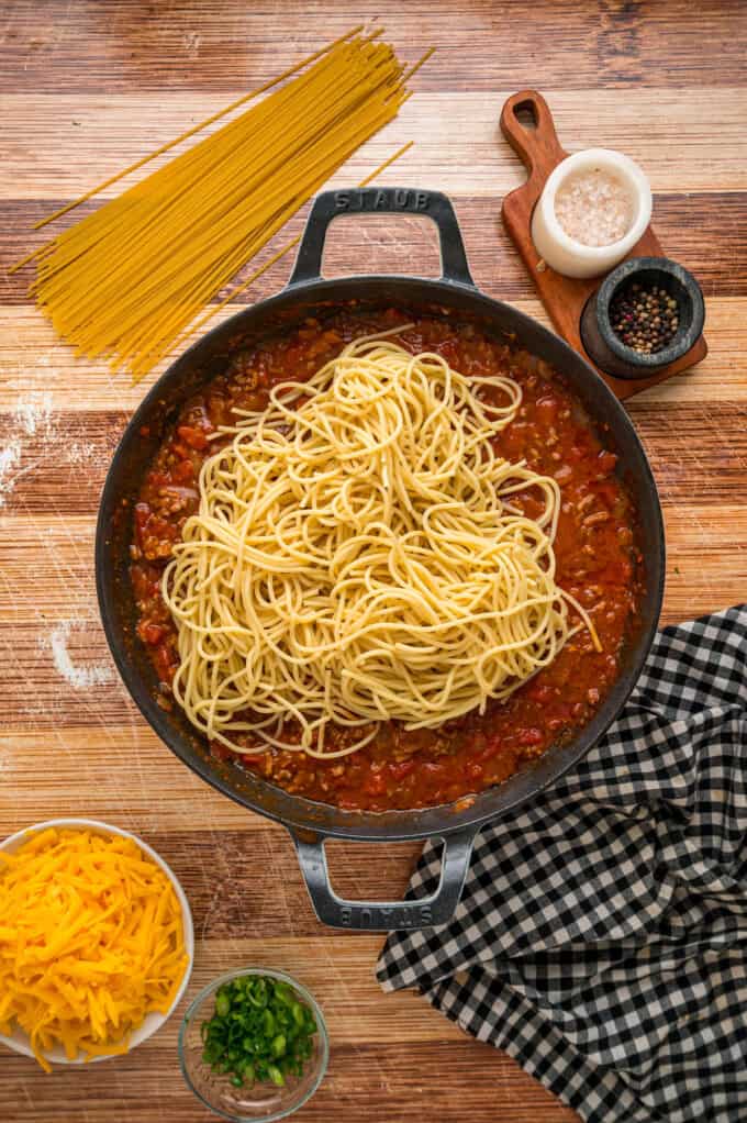 Cowboy Spaghetti is an extra hearty and flavorful take on classic spaghetti, with ground beef, bacon, tomatoes and green chilies, and cheese. Adding spaghetti noodles to the sauce