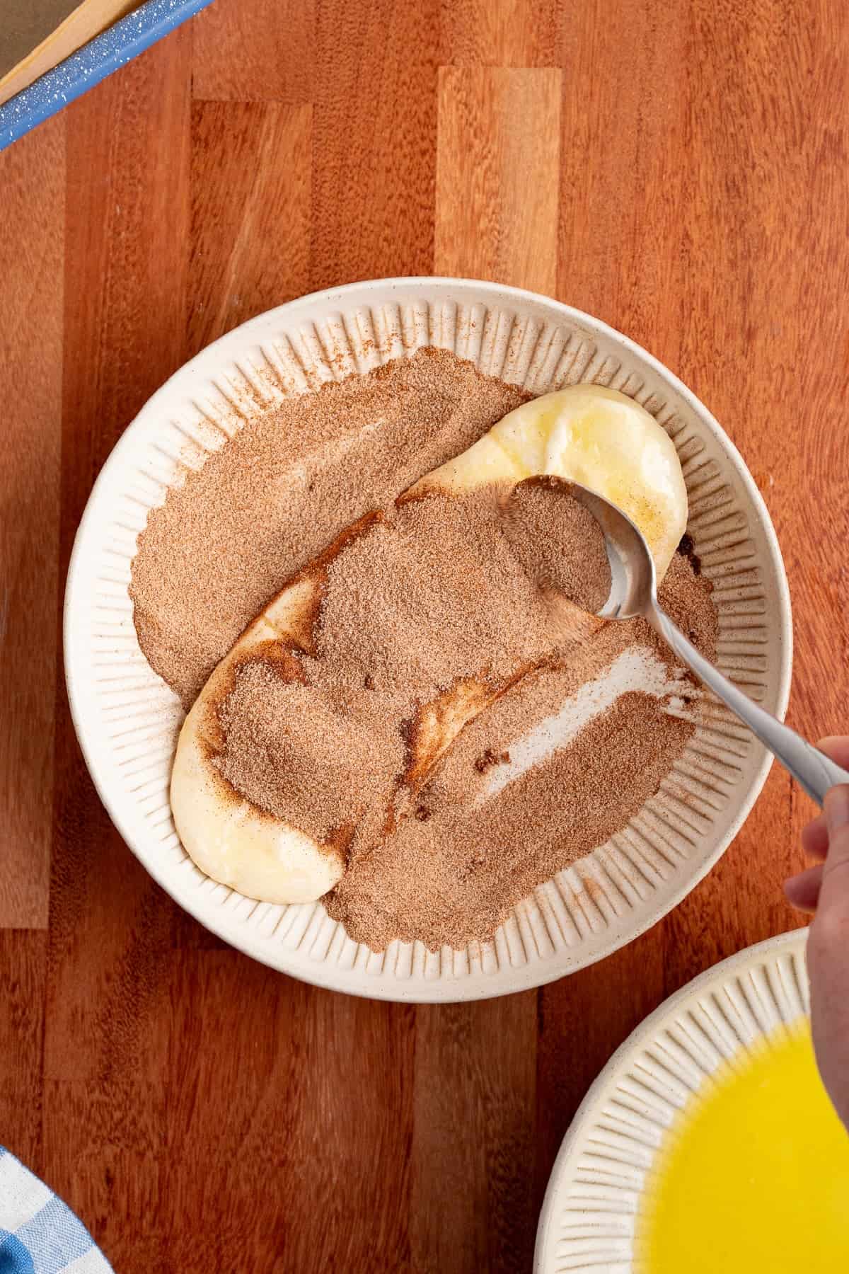 This Dollywood Cinnamon Bread copycat recipe has a buttery, caramelized cinnamon-sugar coating and sweet glaze drizzled over the top. covering bread dough with with a cinnamon sugar mixture