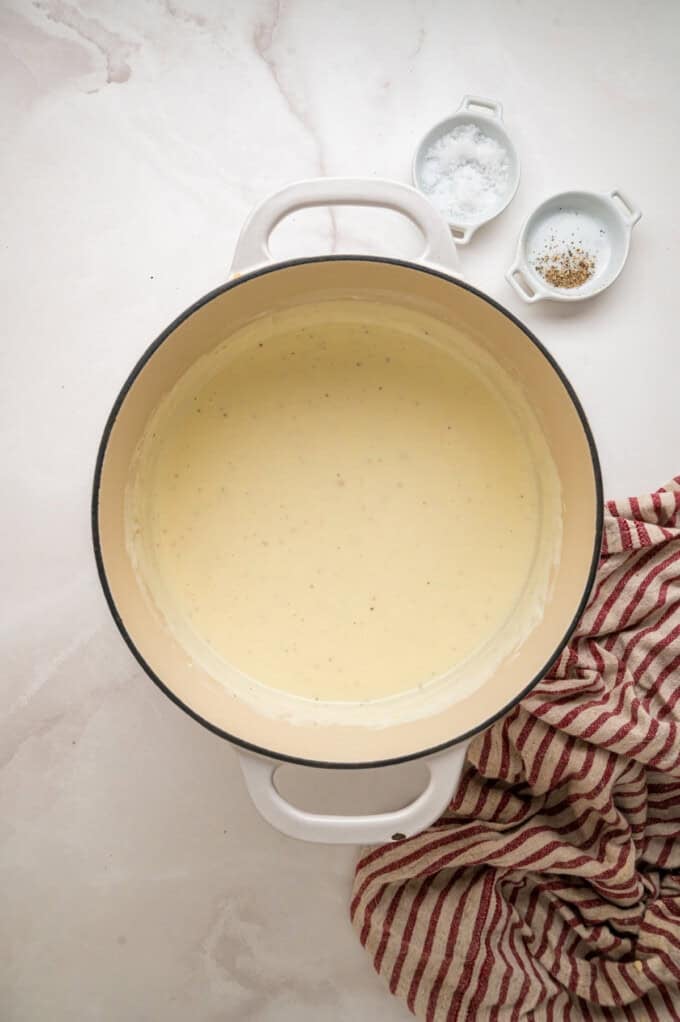 Tender shell pasta is coated in a thick, creamy white cheddar cheese sauce in this copycat Panera Mac and Cheese recipe. White cheddar cheese sauce in a pot
