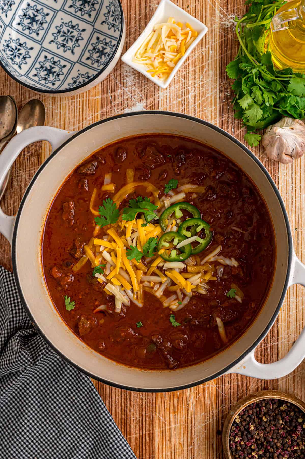Seared chunks of chuck roast are simmered with crushed tomatoes, jalapenos, and chipotles in adobo sauce to make this Texas Chili recipe. Overhead view of a pot of Texas chili
