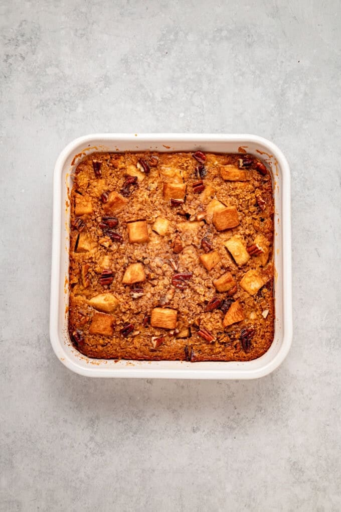 With tender, caramelized apples and lightly spiced maple syrup oats, this Baked Apple Oatmeal is the perfect fall breakfast. Overhead view of a pan of baked apple oatmeal