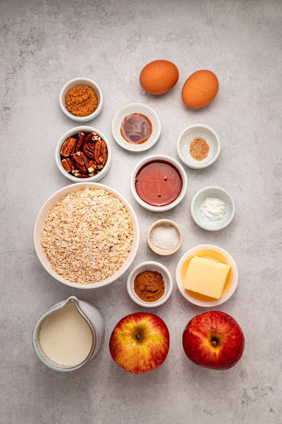 With tender, caramelized apples and lightly spiced maple syrup oats, this Baked Apple Oatmeal is the perfect fall breakfast. Overhead view of ingredients needed to make baked apple oatmeal