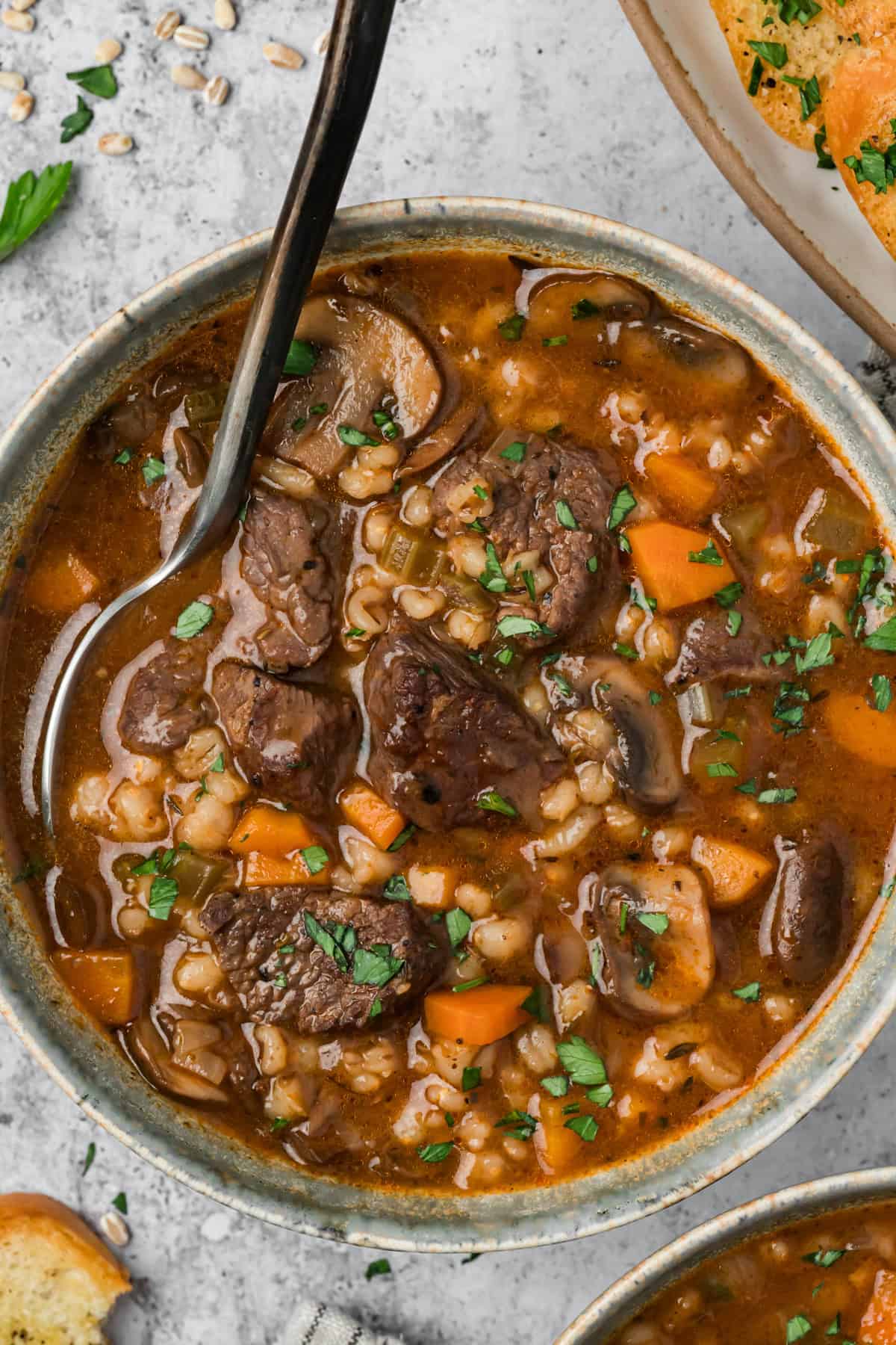 This hearty Beef Barley Mushroom Soup is nourishing, comforting, and perfect for chilly nights, with tender pieces of beef. Beef Barley Mushroom Soup in a serving bowl.