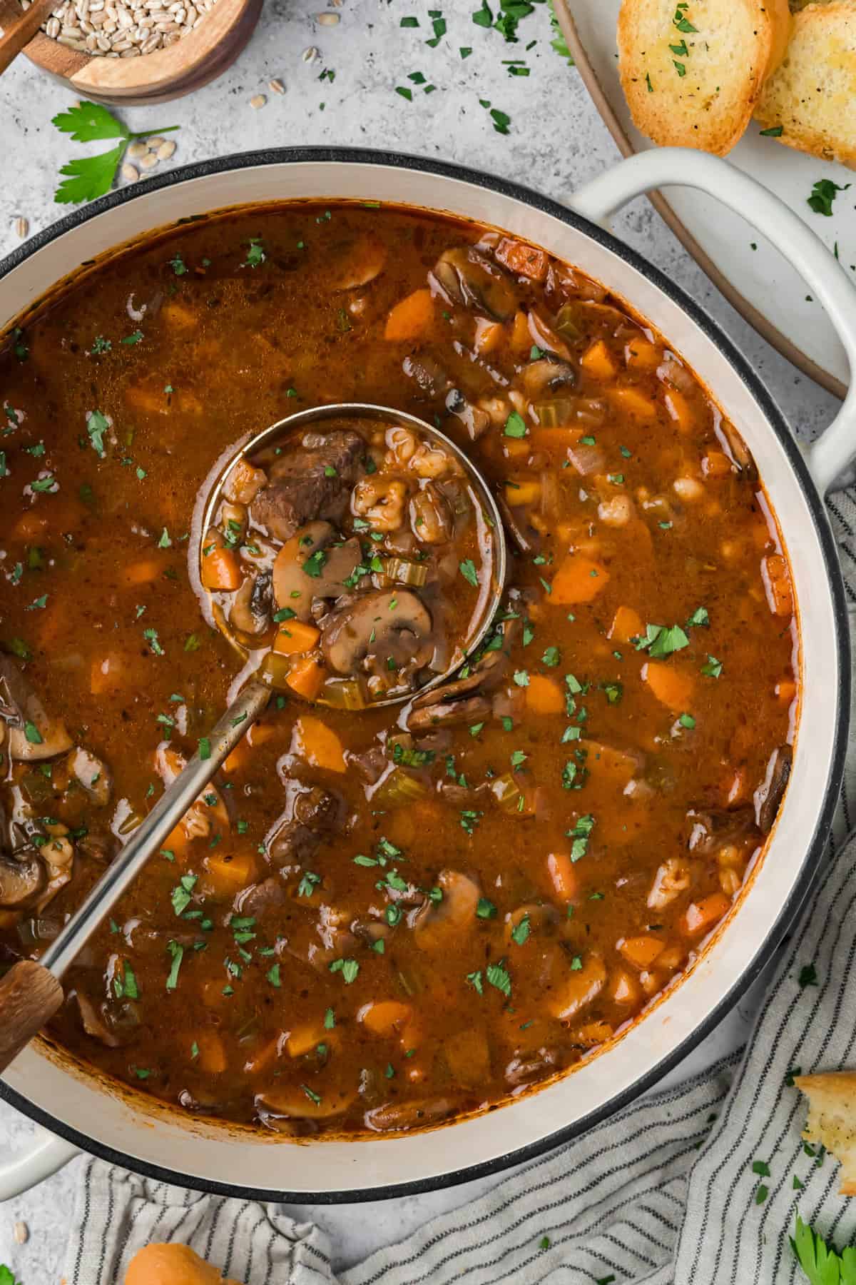 This hearty Beef Barley Mushroom Soup is nourishing, comforting, and perfect for chilly nights, with tender pieces of beef. Beef Barley Mushroom Soup in a pot with a ladle.