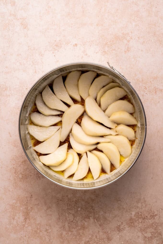 With a moist and tender cake topped with soft caramelized pears, this Pear Upside Down Cake is perfect for fall. Pear slices in the bottom of a pan