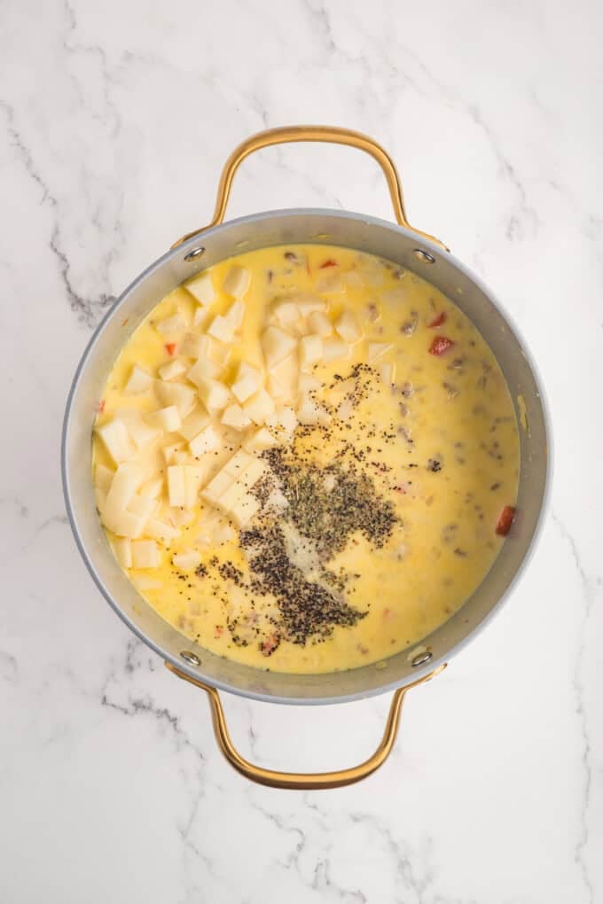 This Sausage Potato Soup is rich, creamy, and loaded with savory Italian sausage, tender potatoes, sweet carrots, and sharp cheddar cheese. Spices added to the potato soup broth