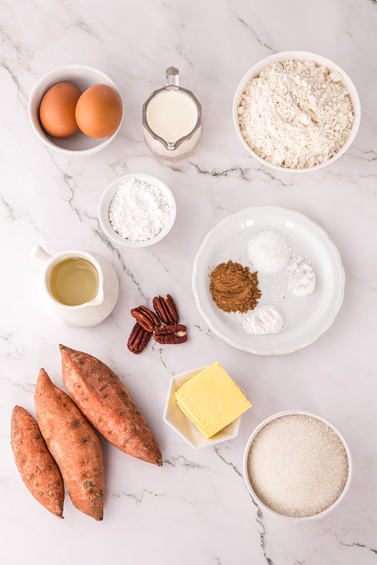 This Sweet Potato Bread is moist, dense, and packed with warm spices. Topped with butter glaze and pecans! Perfect for fall. Overhead view of ingredients needed to make sweet potato bread