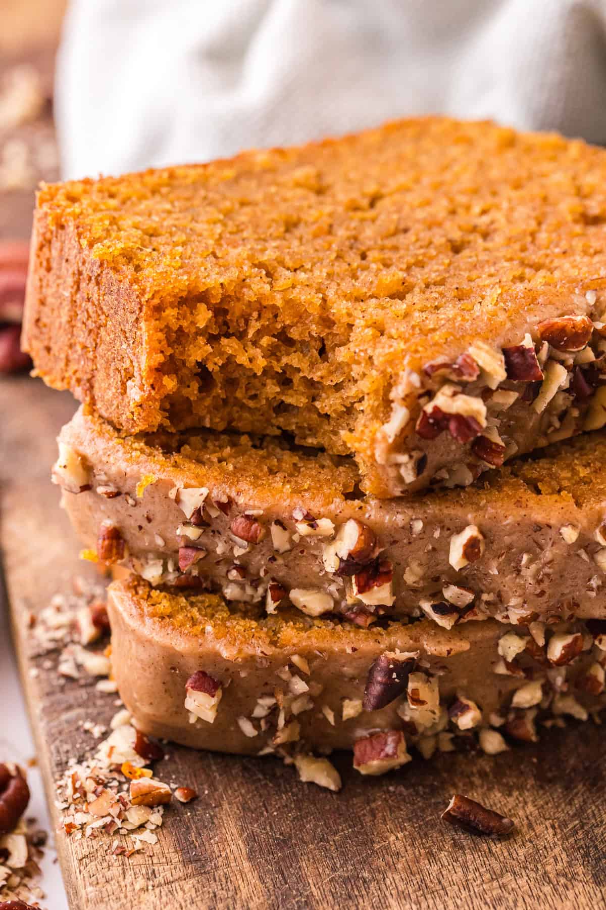 Three slices of sweet potato bread, one with a bite missing