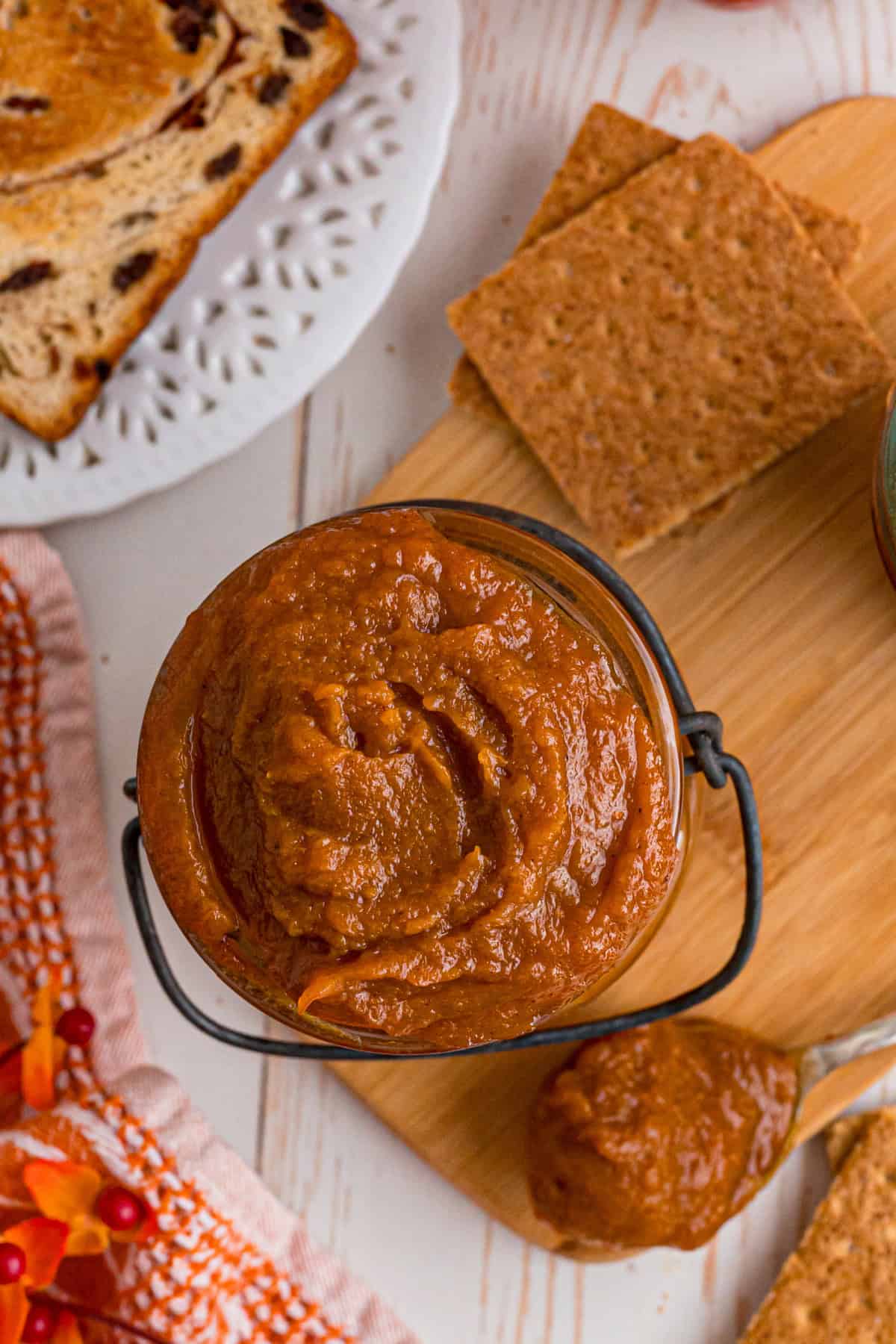 Made with pumpkin puree, brown sugar, maple syrup, and warm spices, you’ll want to spread this Pumpkin Butter on everything. top view of pumpkin butter in a jar