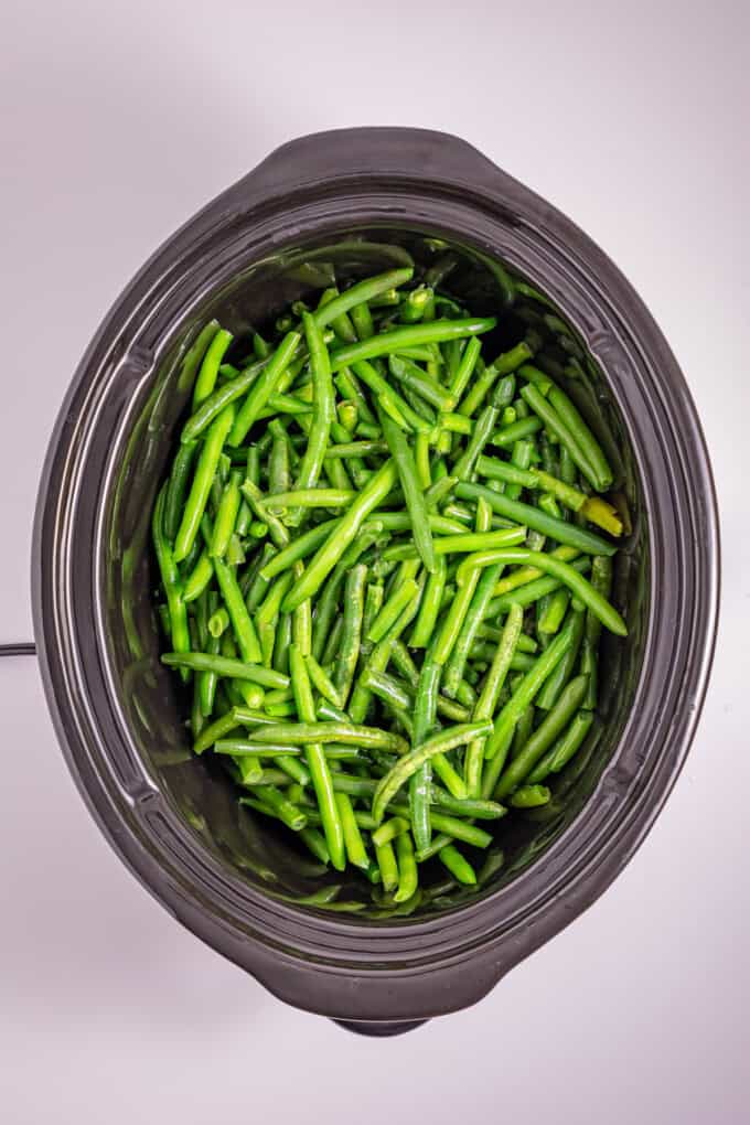 This Slow Cooker Green Bean Casserole is the perfect hands-off side dish for the holidays! Made with just a few ingredients. Green beans in a slow cooker