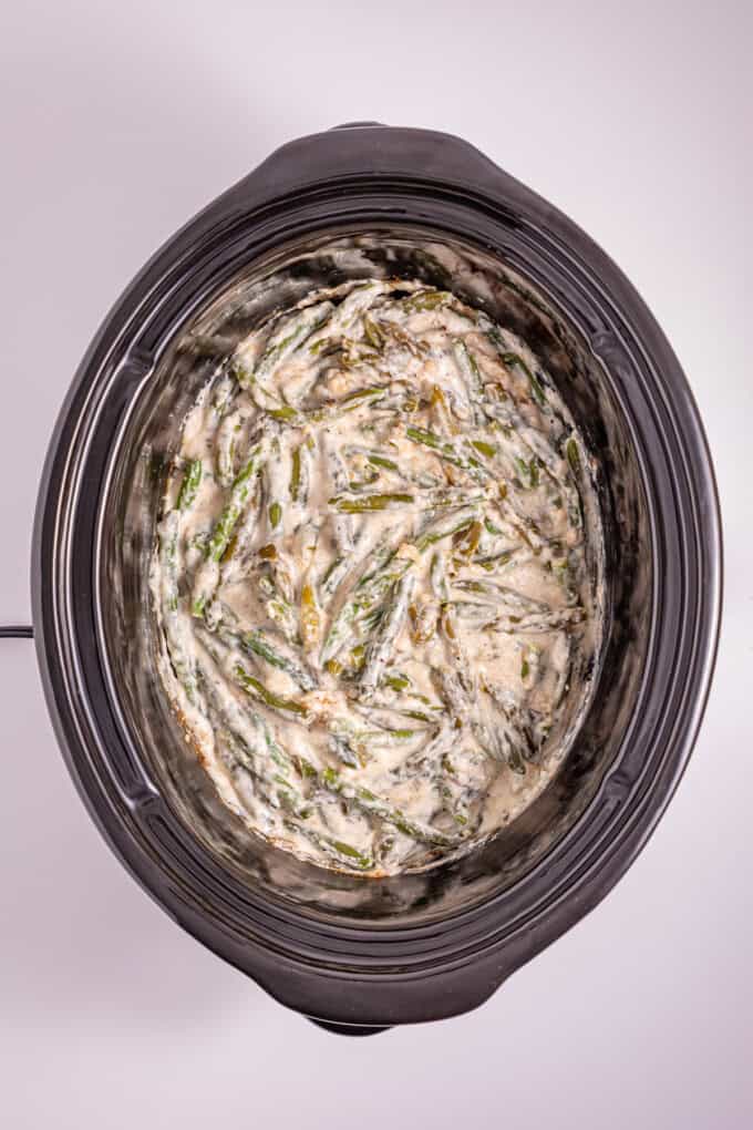 This Slow Cooker Green Bean Casserole is the perfect hands-off side dish for the holidays! Made with just a few ingredients. Green bean casserole in the slow cooker