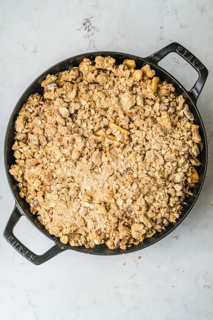 This Apple Cranberry Crisp is baked in a cast-iron skillet, giving the fruit a caramelized edge while the buttery oat turns golden & crunchy. Apple cranberry crisp in a cast iron skillet