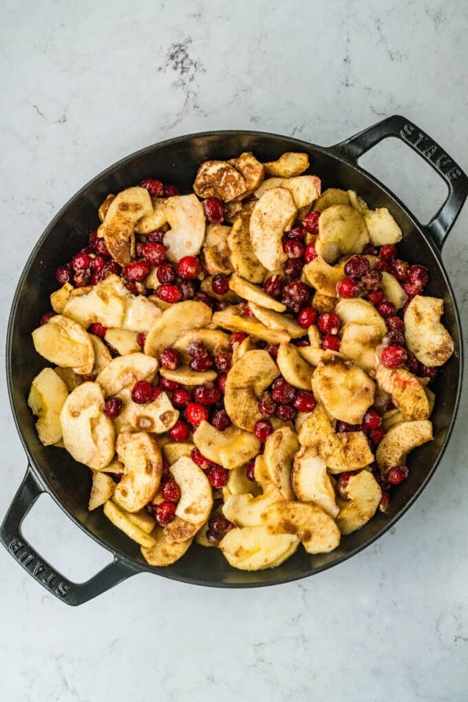 This Apple Cranberry Crisp is baked in a cast-iron skillet, giving the fruit a caramelized edge while the buttery oat turns golden & crunchy. Apples and cranberries in a cast iron skillet