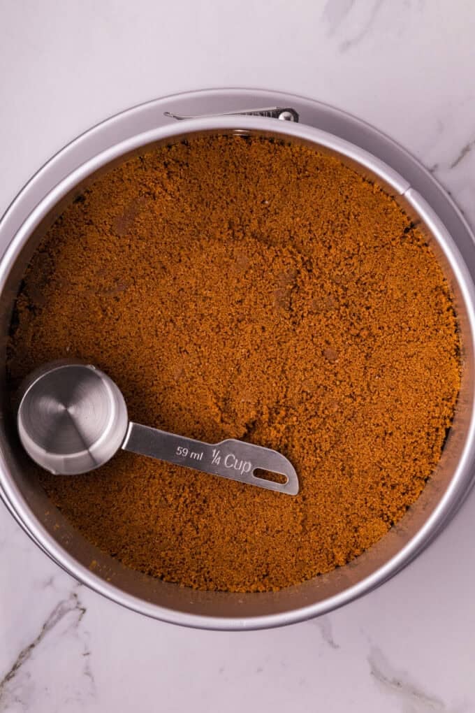 A creamy cookie butter cheesecake filling is baked in a Biscoff crust and topped with more cookie butter in this Biscoff Cheesecake recipe. Biscoff crust in a round pan