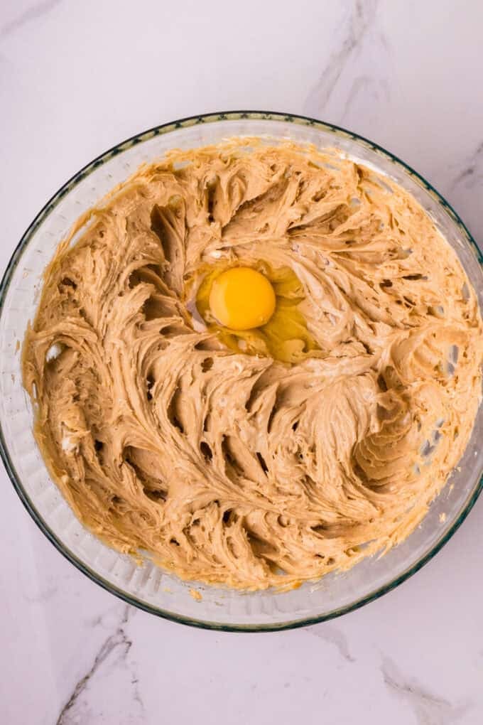 A creamy cookie butter cheesecake filling is baked in a Biscoff crust and topped with more cookie butter in this Biscoff Cheesecake recipe. Mixing egg into cheesecake filling