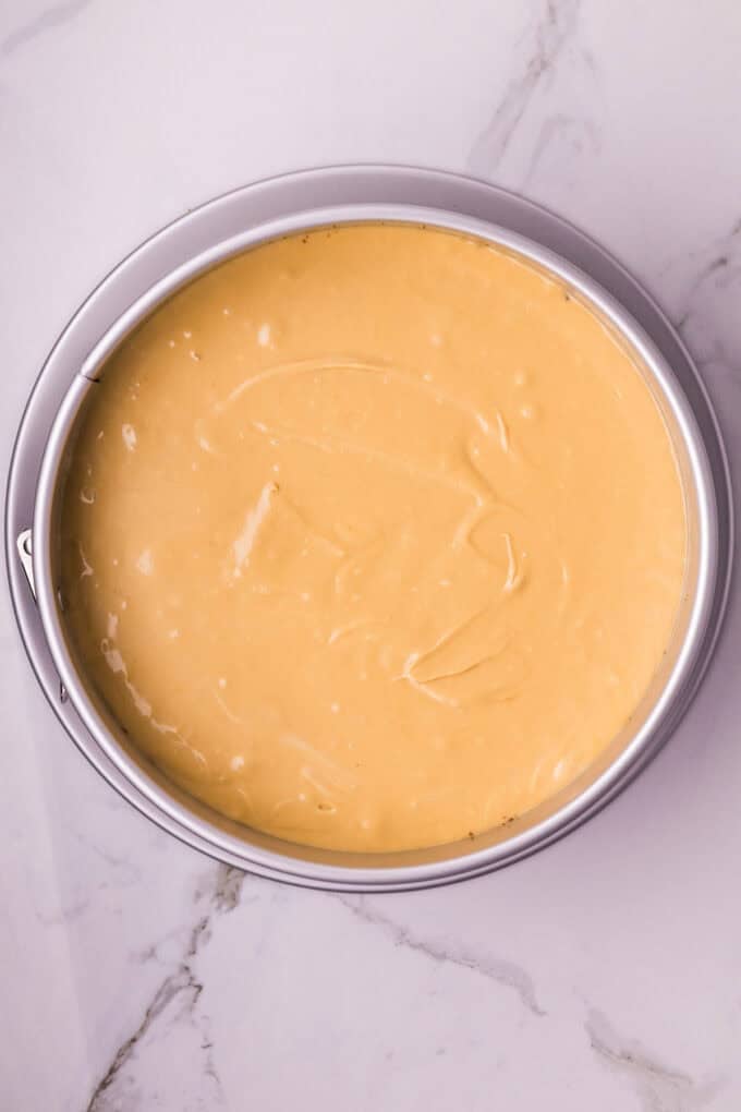 A creamy cookie butter cheesecake filling is baked in a Biscoff crust and topped with more cookie butter in this Biscoff Cheesecake recipe. Biscoff cheesecake filling in a round pan
