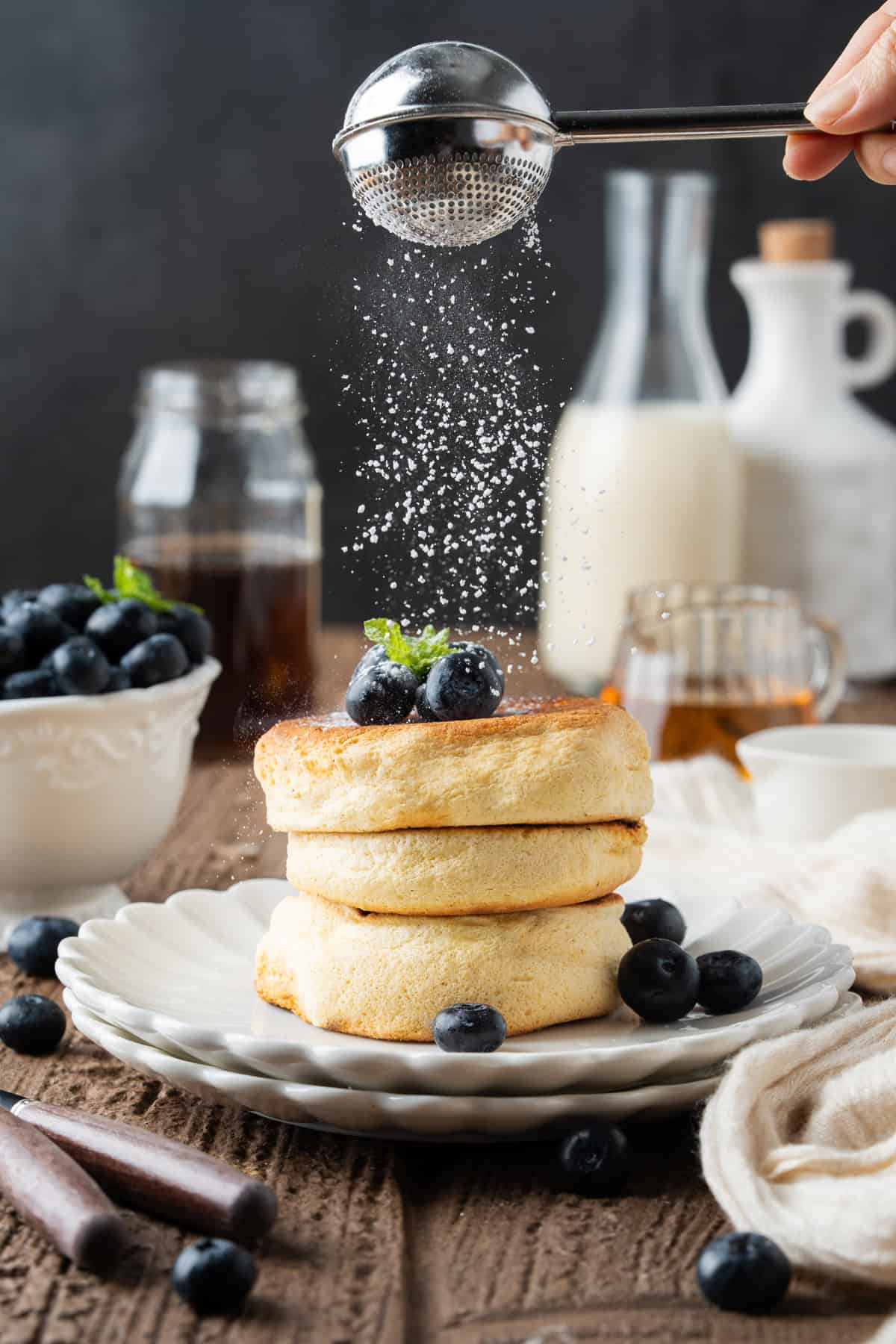 These Japanese Soufflé Pancakes are tall, fluffy, jiggly, and unbelievably soft, thanks to the meringue in the batter. Sprinkling powdered sugar over a plate of Japanese souffle pancakes