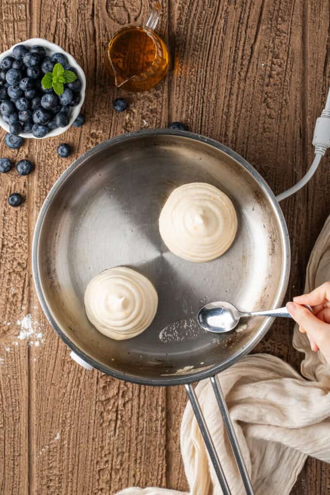 These Japanese Soufflé Pancakes are tall, fluffy, jiggly, and unbelievably soft, thanks to the meringue in the batter. Extra batter piped onto Japanese souffle pancakes