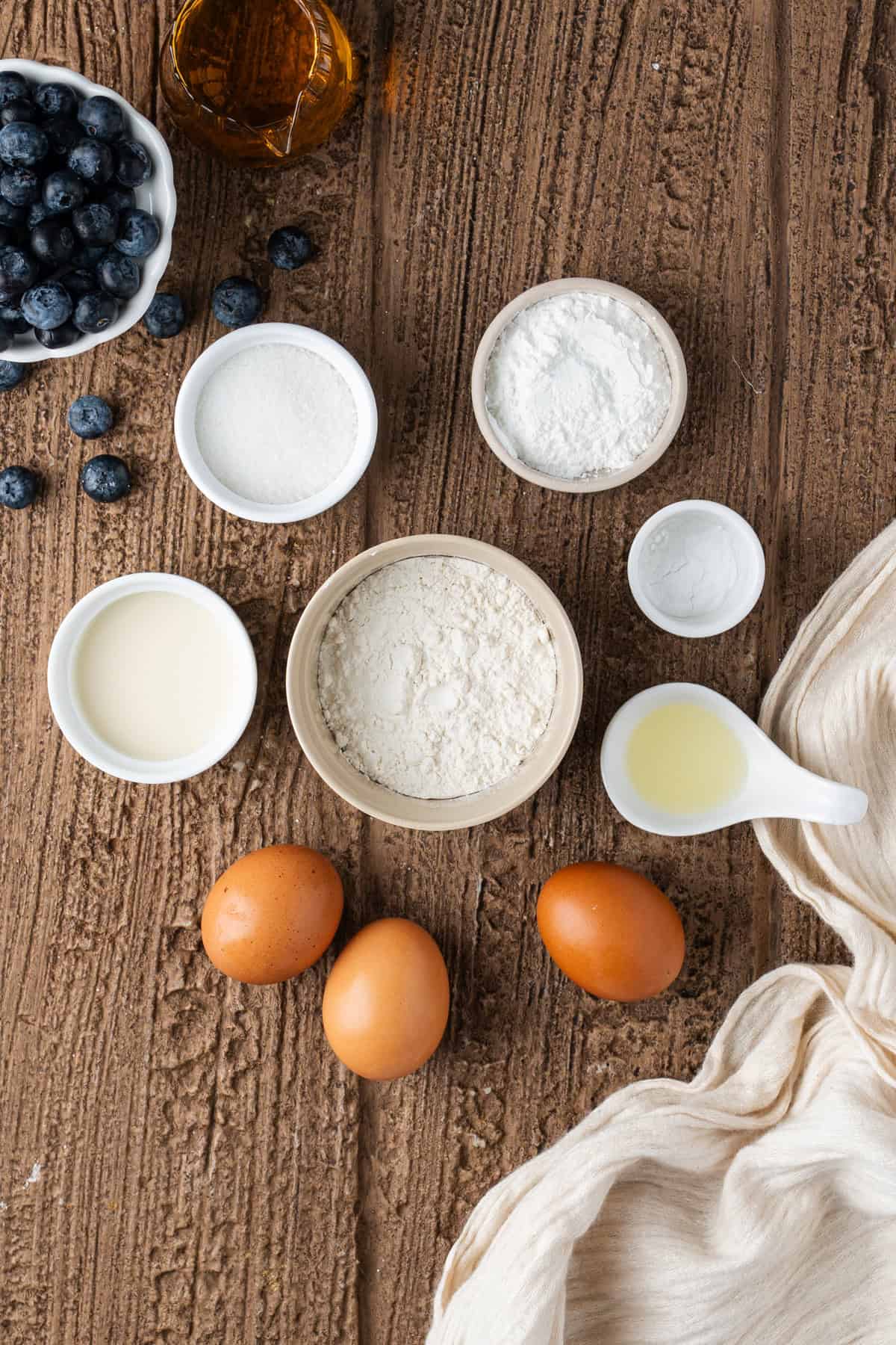 These Japanese Soufflé Pancakes are tall, fluffy, jiggly, and unbelievably soft, thanks to the meringue in the batter. Overhead view of ingredients needed to make Japanese souffle pancakes