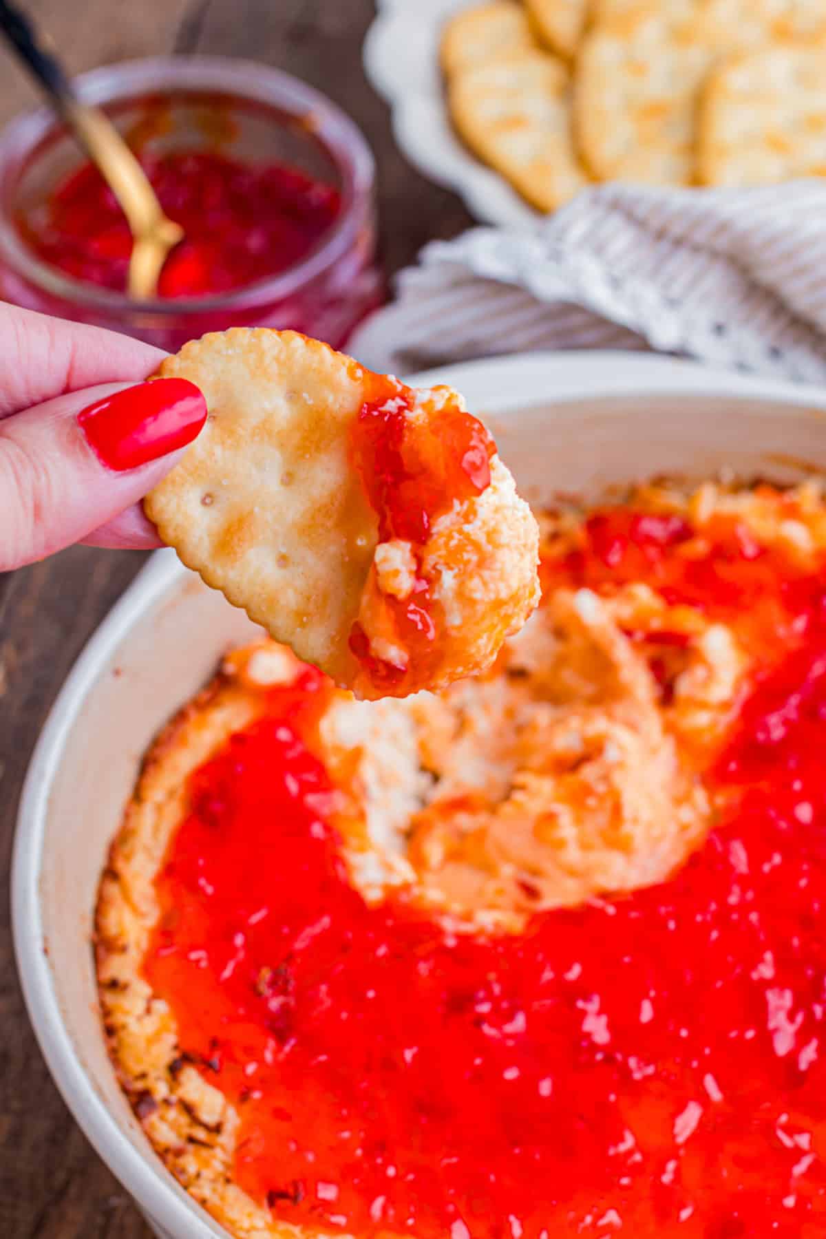 This easy Pepper Jelly Cream Cheese Dip is creamy, cheesy, smoky, and perfectly sweet and spicy! Perfect for holidays & game days. Pepper Jelly Cream Cheese Dip on a cracker.
