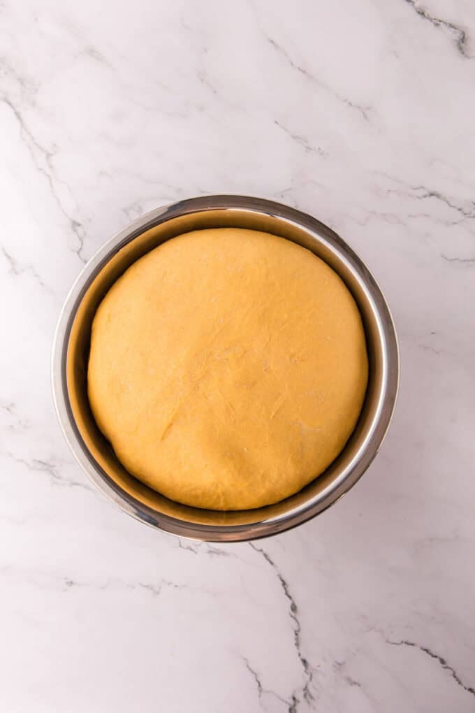 These soft, fluffy Sweet Potato Rolls are brushed with warm honey butter right out of the oven. Easy to make with a few basic ingredients! Sweet potato roll dough after rising