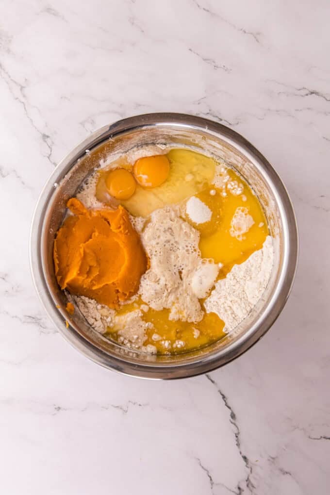 These soft, fluffy Sweet Potato Rolls are brushed with warm honey butter right out of the oven. Easy to make with a few basic ingredients! Dry ingredients, eggs, sweet potatoes, and yeast in a bowl