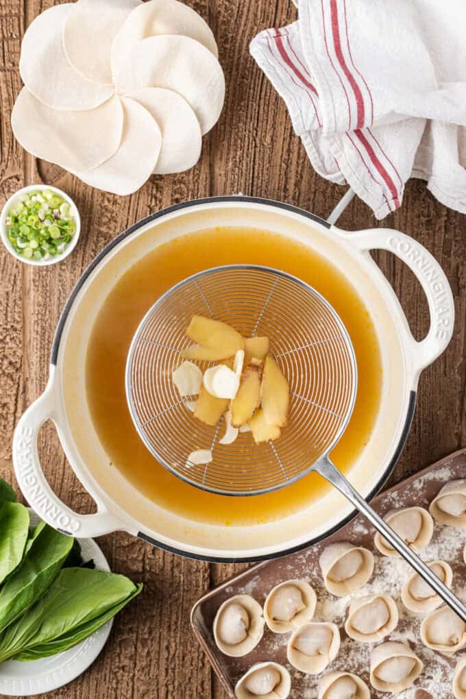 This easy Wonton Soup features tender homemade wontons filled with juicy pork and shrimp in a light, aromatic chicken broth. Straining ginger and garlic from the broth