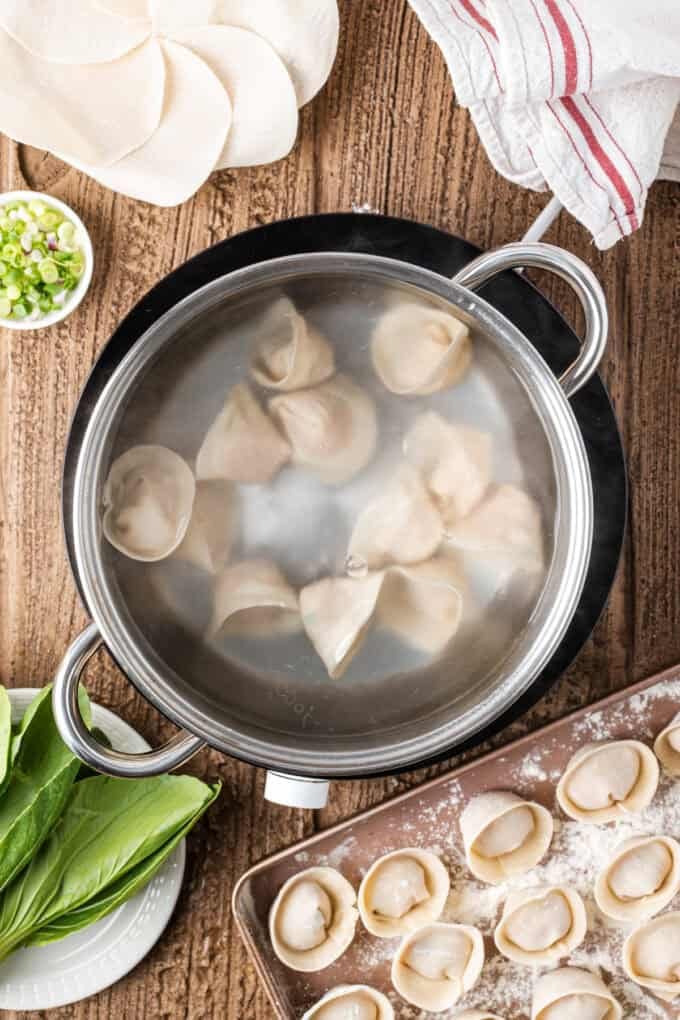 This easy Wonton Soup features tender homemade wontons filled with juicy pork and shrimp in a light, aromatic chicken broth. Homemade wontons boiling in water