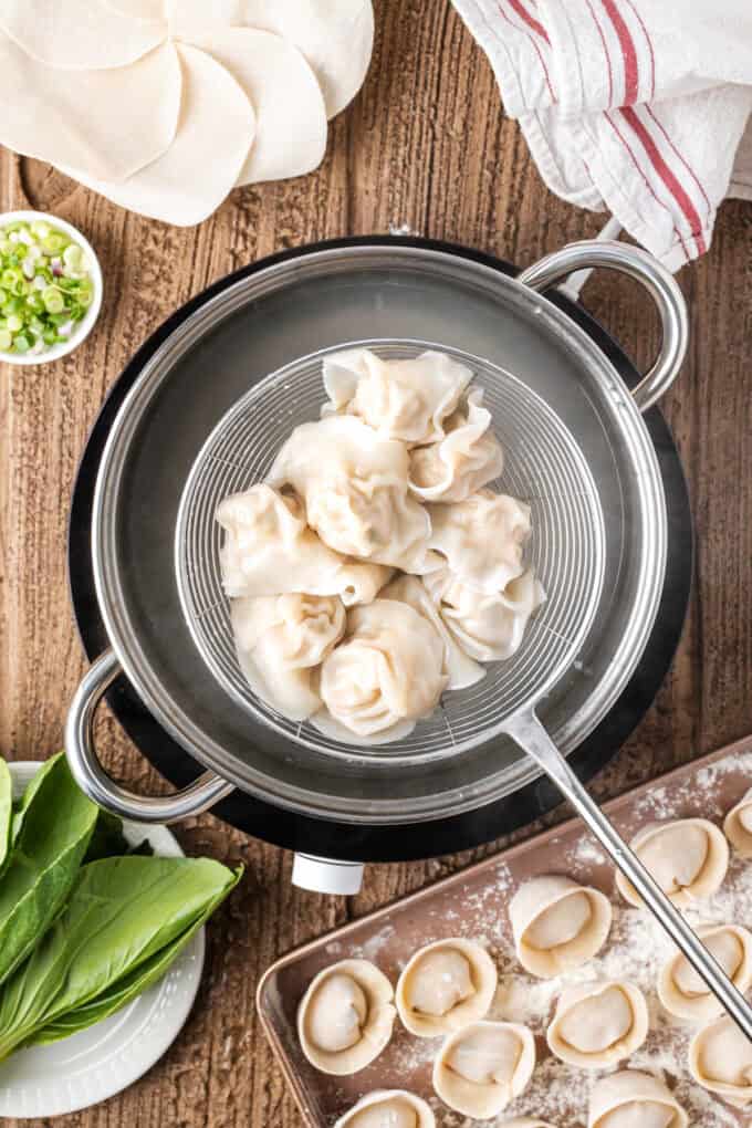 This easy Wonton Soup features tender homemade wontons filled with juicy pork and shrimp in a light, aromatic chicken broth. Straining wontons from water