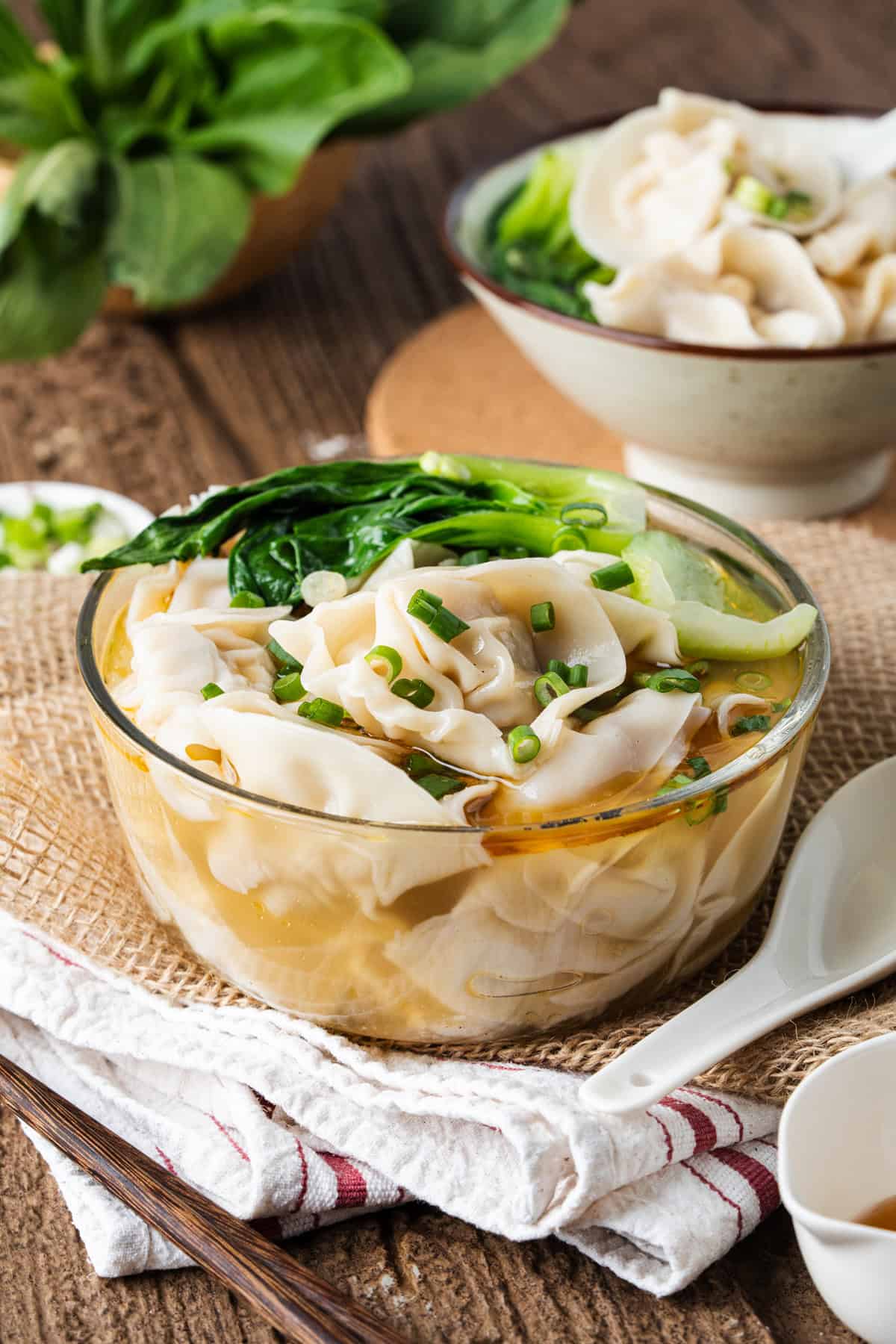 This easy Wonton Soup features tender homemade wontons filled with juicy pork and shrimp in a light, aromatic chicken broth. A glass bowl of wonton soup