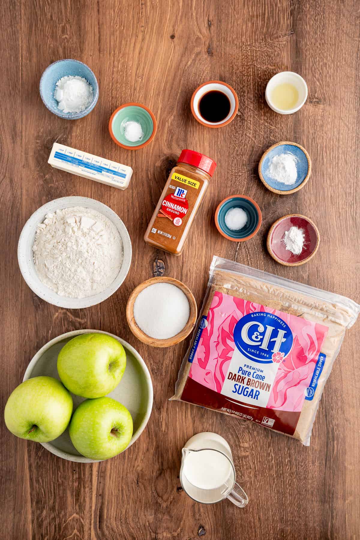 Tender spiced apple filling is topped with a snickerdoodle batter to make this irresistible Apple Cobbler recipe. Overhead view of ingredients needed to make apple cobbler