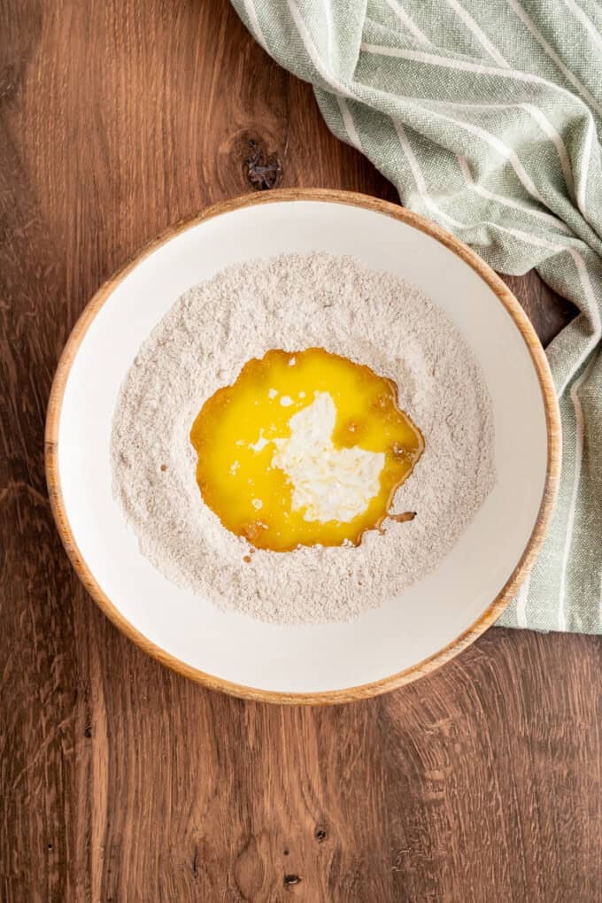 Tender spiced apple filling is topped with a snickerdoodle batter to make this irresistible Apple Cobbler recipe. Cobbler topping ingredients in a bowl