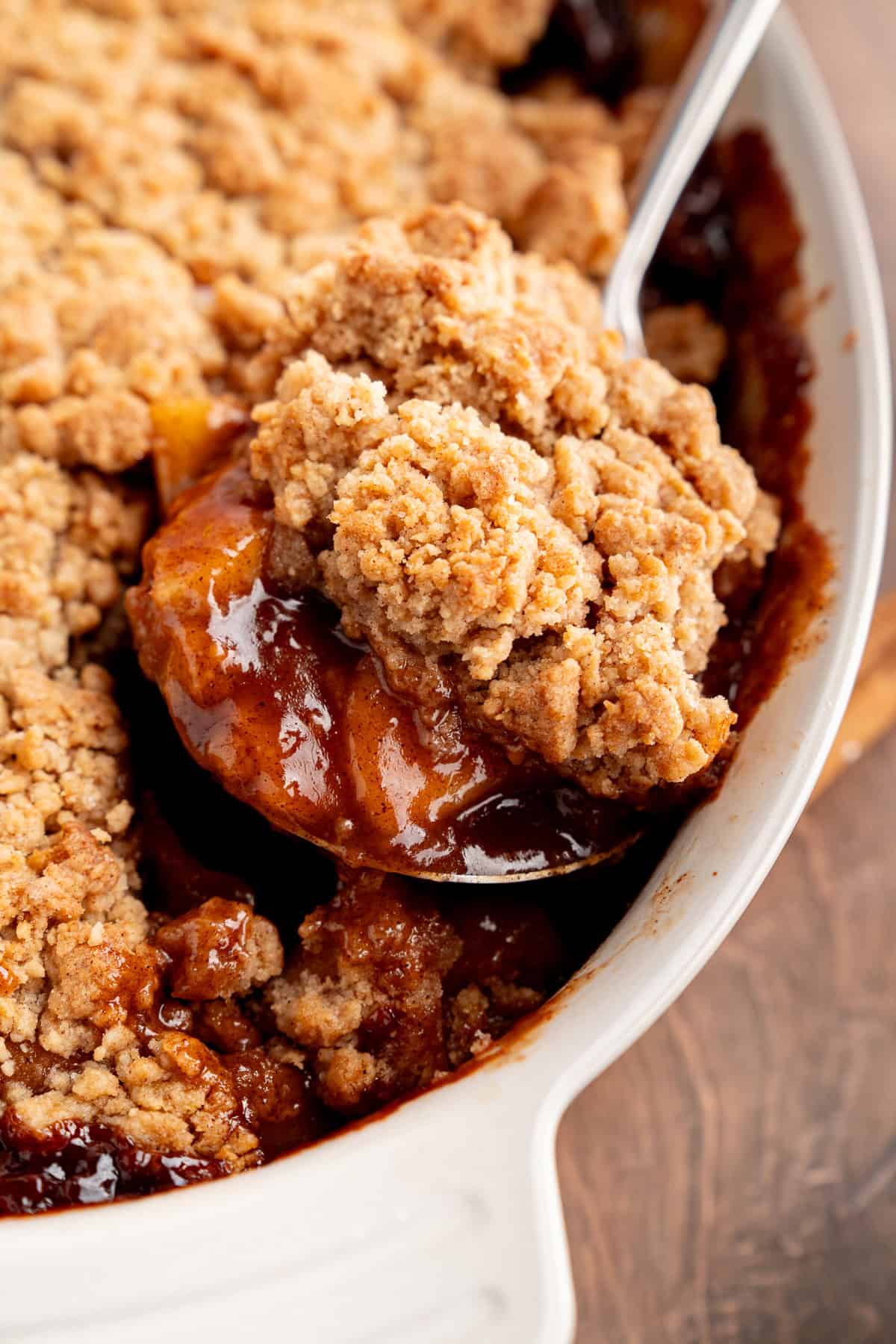 Tender spiced apple filling is topped with a snickerdoodle batter to make this irresistible Apple Cobbler recipe. Serving a spoonful of apple cobbler