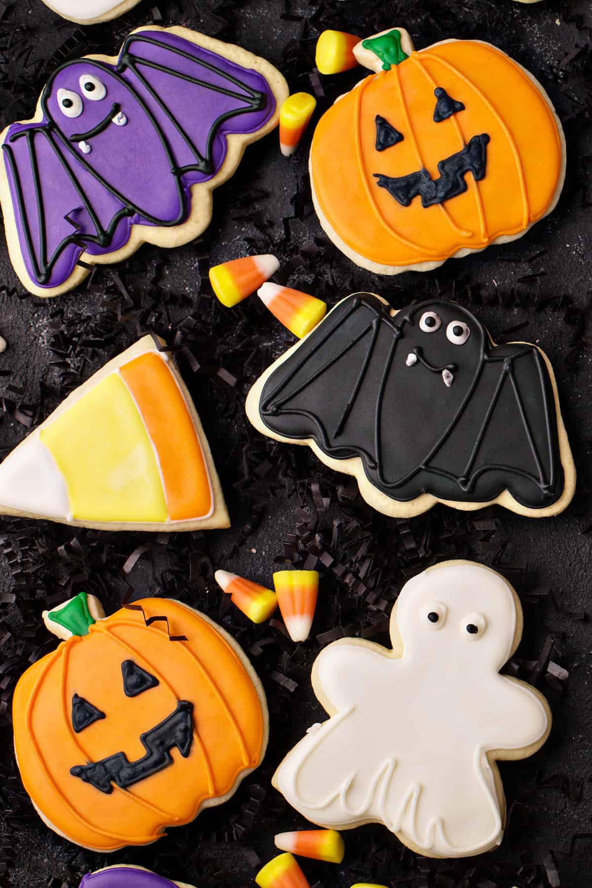 These Halloween Sugar Cookies are soft, buttery cut-out cookies decorated with colorful icing for a fun and festive Halloween treat. Halloween Sugar Cookies with a black background