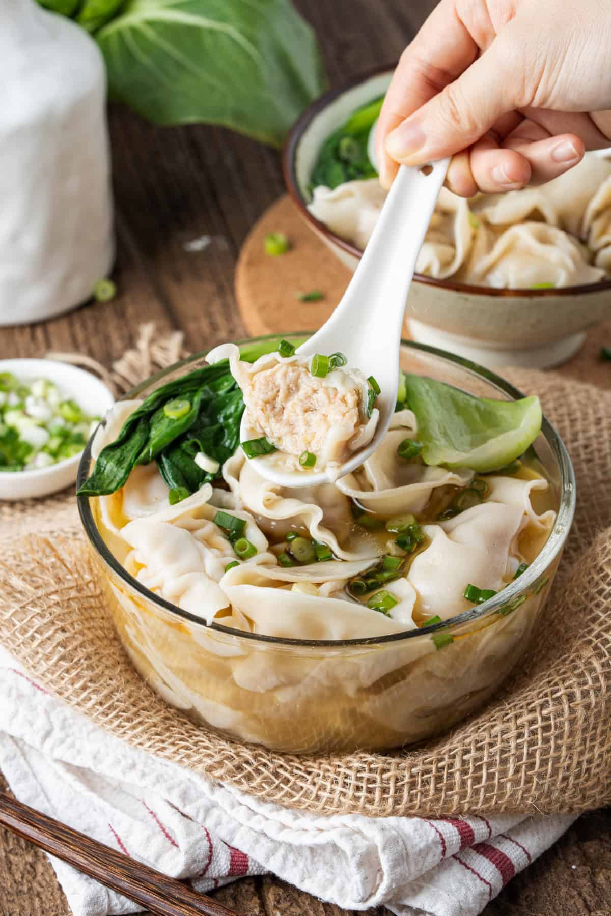 This easy Wonton Soup features tender homemade wontons filled with juicy pork and shrimp in a light, aromatic chicken broth. Wonton Soup with a spoon.